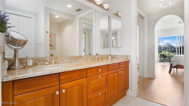 bathroom with ceiling fan, hardwood / wood-style floors, and vanity