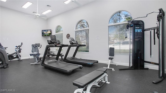 gym featuring ceiling fan and a high ceiling