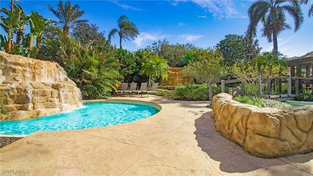 view of pool with pool water feature and a patio area