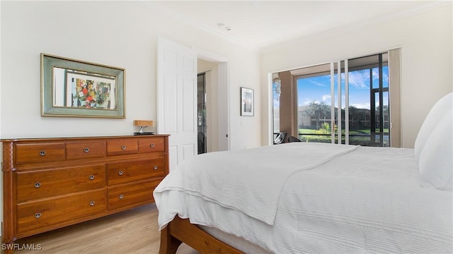 bedroom with access to exterior, light hardwood / wood-style flooring, and crown molding