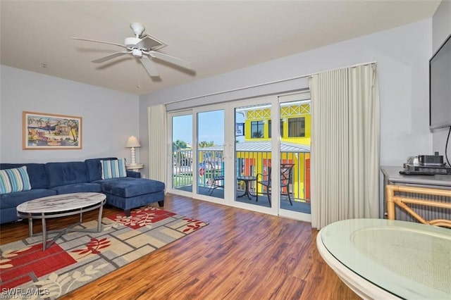 living room with ceiling fan and hardwood / wood-style floors