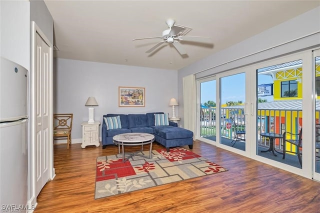 living room with hardwood / wood-style flooring and ceiling fan