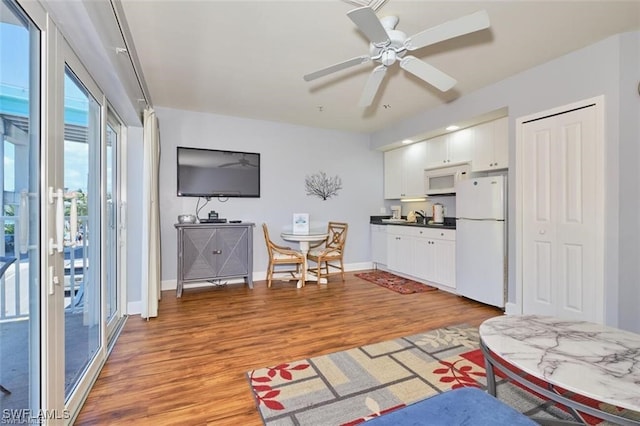 living room featuring light wood-type flooring and ceiling fan