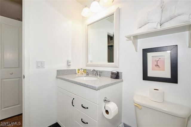 bathroom with hardwood / wood-style floors, vanity, and toilet