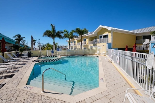 view of pool featuring a patio and a hot tub