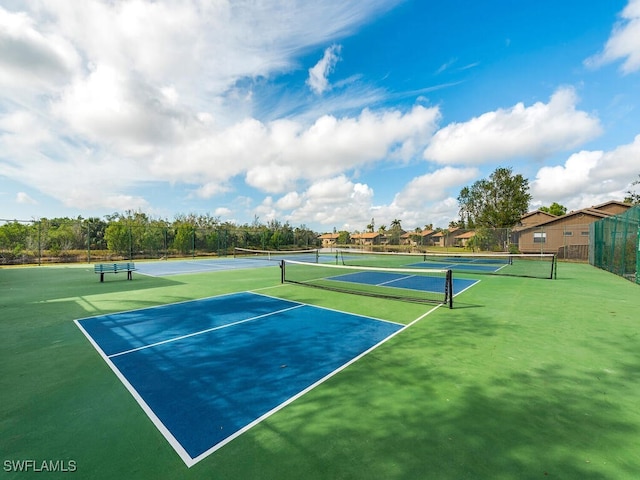 view of tennis court with basketball hoop