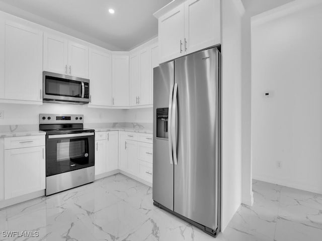 kitchen featuring light stone counters, recessed lighting, stainless steel appliances, white cabinets, and marble finish floor