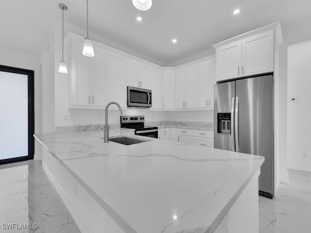 kitchen with light stone counters, a peninsula, a sink, appliances with stainless steel finishes, and marble finish floor