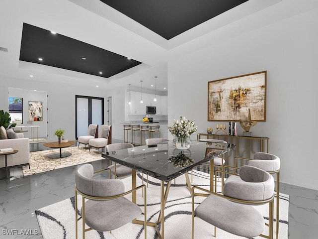 dining space with visible vents, baseboards, a tray ceiling, recessed lighting, and marble finish floor