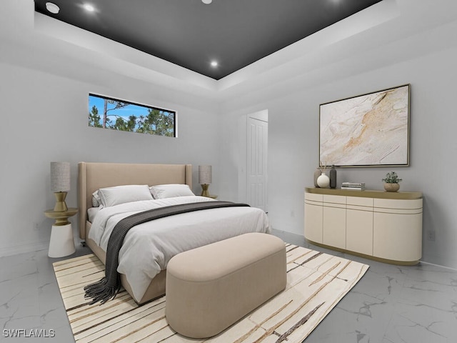 bedroom featuring a raised ceiling, baseboards, and marble finish floor