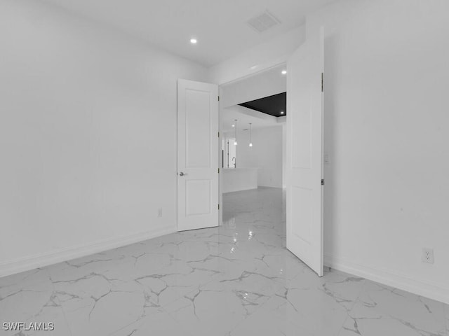 spare room featuring recessed lighting, baseboards, visible vents, and marble finish floor