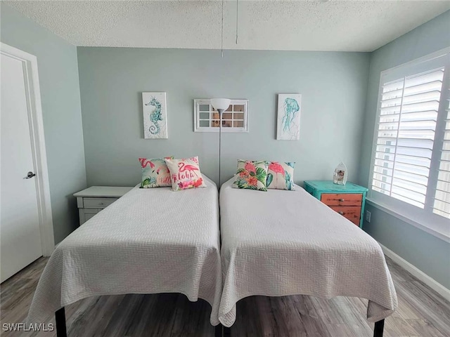 bedroom featuring light hardwood / wood-style flooring and a textured ceiling