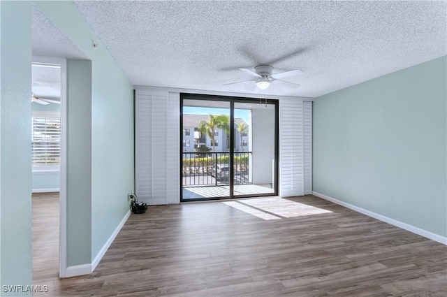 empty room featuring hardwood / wood-style floors, a textured ceiling, and ceiling fan