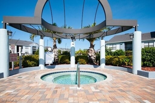 view of pool with a community hot tub