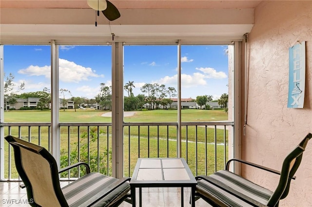 sunroom featuring ceiling fan