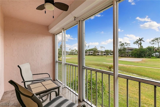 sunroom featuring ceiling fan