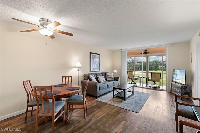 living room with ceiling fan, dark hardwood / wood-style flooring, and a textured ceiling