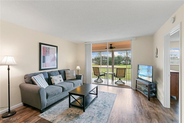 living room featuring a textured ceiling and dark hardwood / wood-style floors