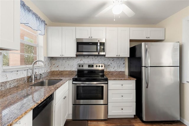 kitchen featuring white cabinets, light stone counters, sink, and appliances with stainless steel finishes