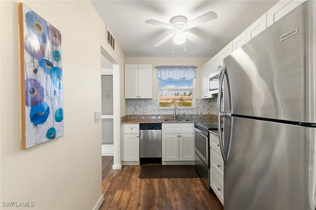 kitchen featuring white cabinetry, sink, tasteful backsplash, dark hardwood / wood-style flooring, and appliances with stainless steel finishes