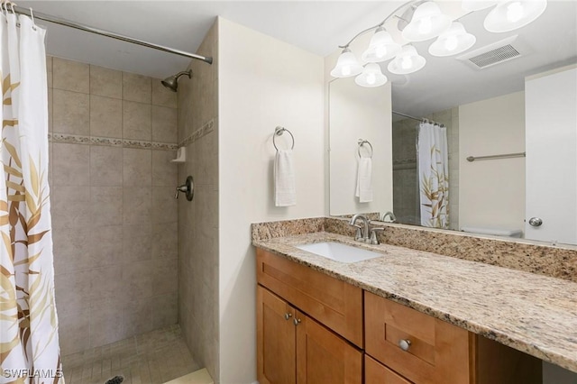 bathroom with curtained shower, vanity, and toilet