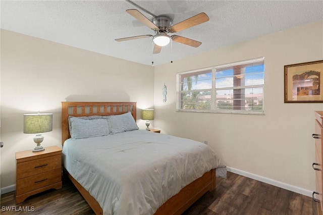 bedroom with a textured ceiling, dark hardwood / wood-style floors, and ceiling fan