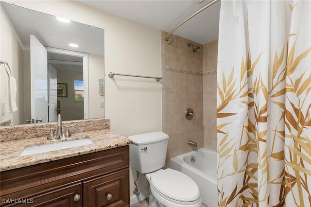 full bathroom featuring shower / tub combo with curtain, vanity, and toilet