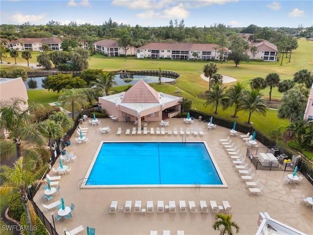 view of pool featuring a water view and a patio