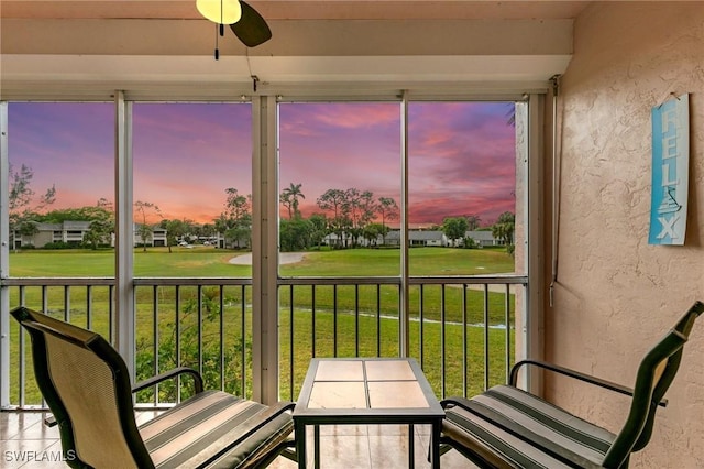 sunroom / solarium featuring ceiling fan