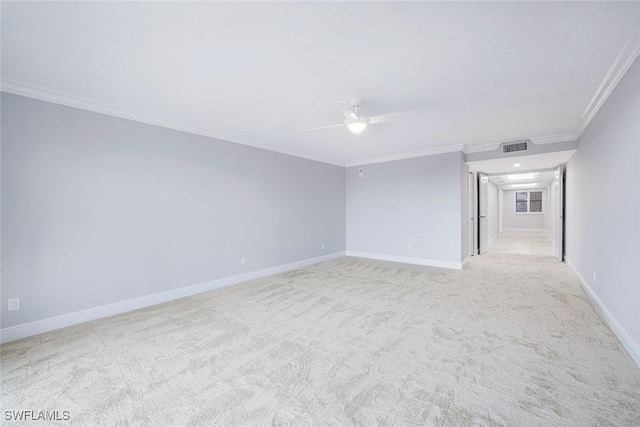 empty room featuring ceiling fan, ornamental molding, and light carpet