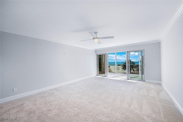 spare room with light carpet, ceiling fan, and ornamental molding