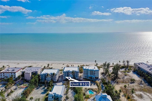 aerial view featuring a water view and a beach view