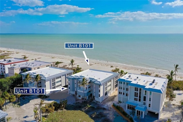 birds eye view of property with a beach view and a water view