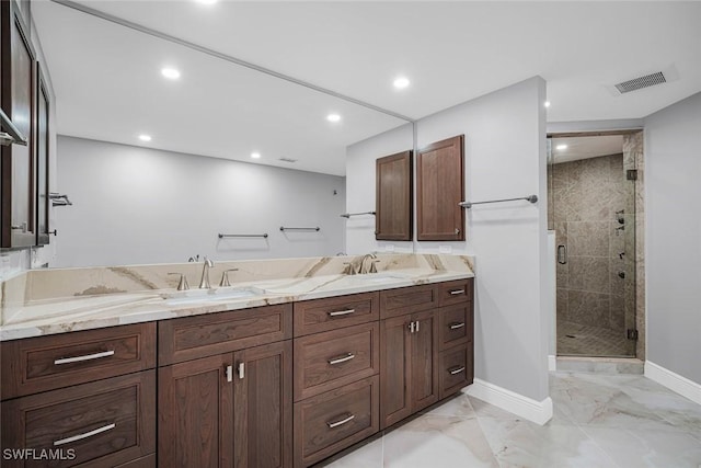 bathroom with vanity and a shower with door