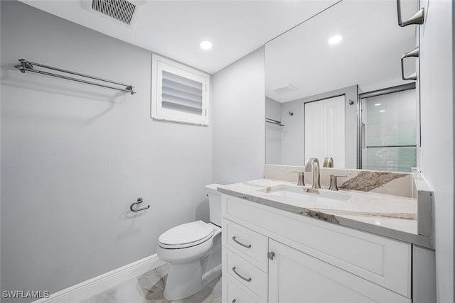 bathroom with vanity, toilet, and an enclosed shower