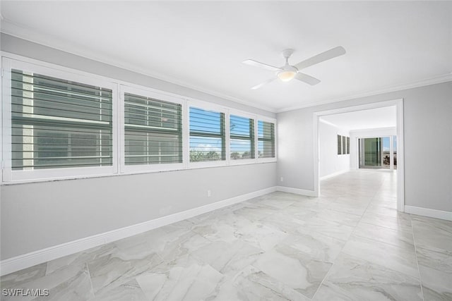 empty room featuring ceiling fan and ornamental molding