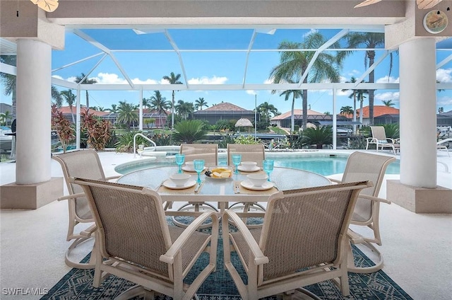 view of pool with a patio and glass enclosure