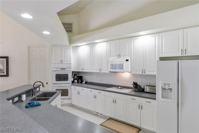 kitchen featuring white cabinets, white appliances, sink, and backsplash