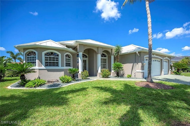 view of front of house with a garage and a front lawn