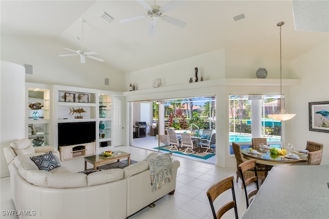 living room with ceiling fan, high vaulted ceiling, and light tile patterned floors