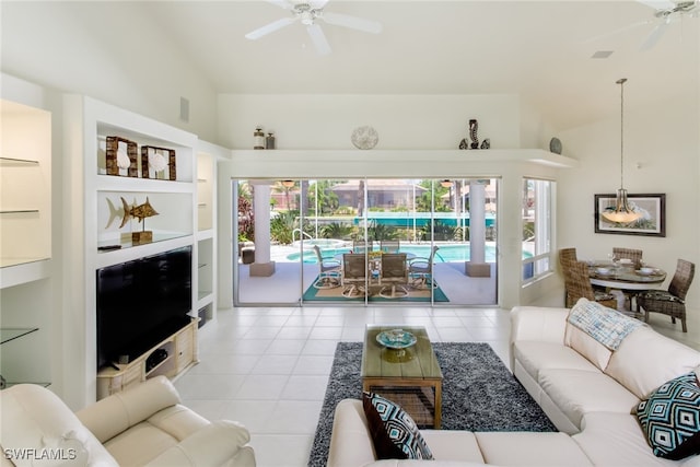 living room featuring ceiling fan, light tile patterned flooring, and high vaulted ceiling