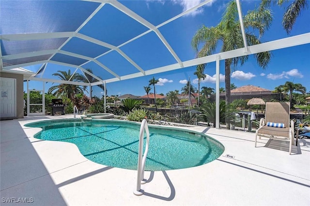 view of swimming pool with glass enclosure and a patio area