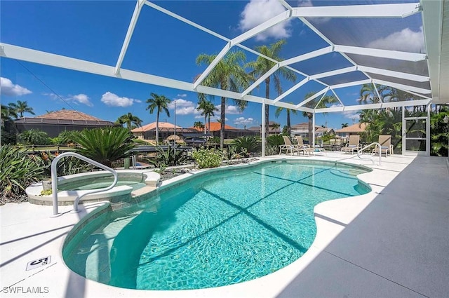 view of pool with an in ground hot tub, a lanai, and a patio area