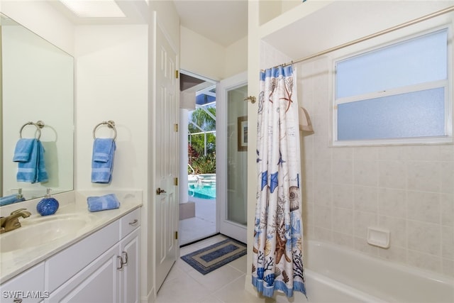 bathroom featuring tile patterned floors, vanity, and shower / bath combo with shower curtain