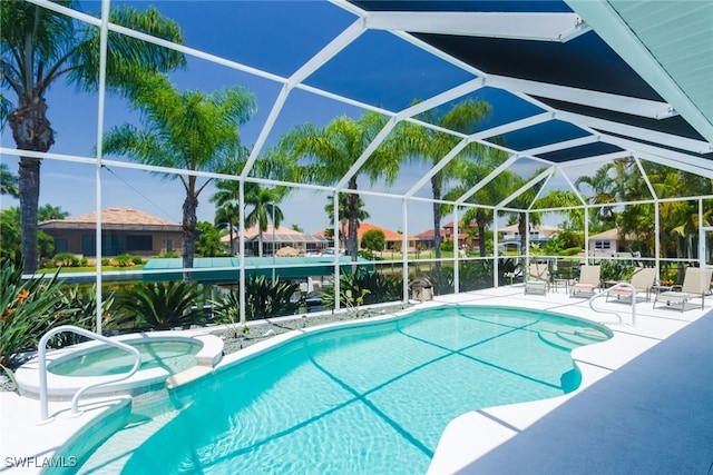 view of swimming pool featuring a lanai, a patio area, and an in ground hot tub