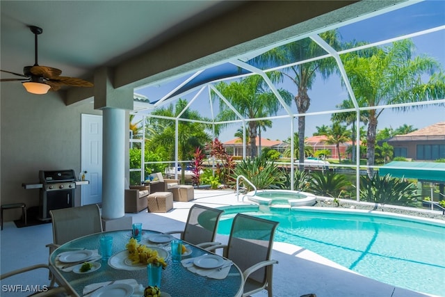 view of swimming pool featuring ceiling fan, a lanai, an in ground hot tub, a grill, and a patio area