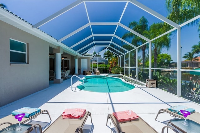 view of pool with a patio, ceiling fan, and a lanai