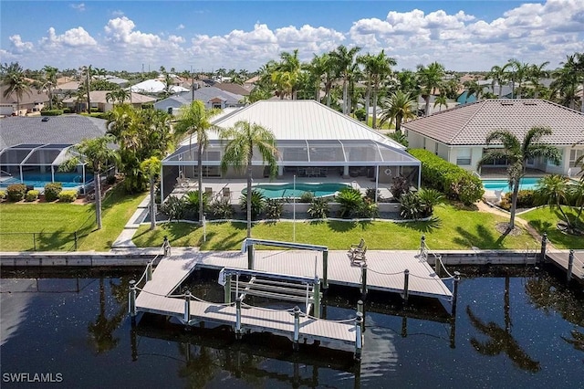 view of dock featuring a water view, glass enclosure, and a lawn