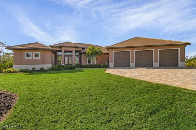 view of front of property featuring a garage and a front yard