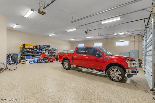 garage featuring electric panel and a garage door opener